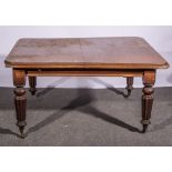 Victorian mahogany extending dining table with a single leaf, ringed and fluted legs,