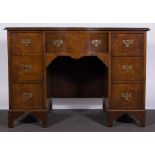 A mahogany serpentine fronted twin pedestal desk,