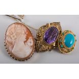 Four brooches, an oval carved shell cameo in a 9 carat yellow gold mount,