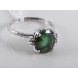 A green stone dress ring, the oval mixed cut tourmaline 10.5mm x 8.