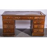 Twin pedestal mahogany desk, with an arrangement of nine drawers surrounding the kneehole,