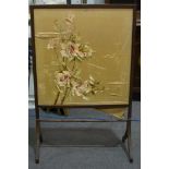 An Edwardian mahogany framed firescreen, embroidered silkwork panel, W66cm, H104cm.