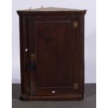 Late Georgian oak hanging corner cupboard, moulded cornice, panelled door,