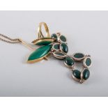 A collection of jewellery set with green stones all in yellow metal,