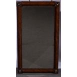 Victorian walnut wall mirror, rectangular bevelled plate, the frame with corner roundels,