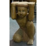 Pair of Malaysian carved teak table bases, designed as crouching boys, 51cm.