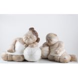 Two Asian style carved wooden figures of a sleeping boy and girl on water melons, (2).