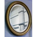 Oval gilt framed mirror, 63cm by 52cm.