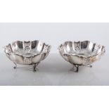 Pair of Edwardian silver bonbon dishes, serpentine circular form, with pierced panels,