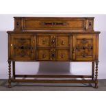 A 1940's oak sideboard, rectangular top, with raised back, fitted drawers and cupboards,