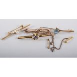 Four bar brooches, two marked 9ct, one with blue stone and seed pearls,