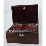 Victorian rosewood travelling box, fitted interior, the accessories with silver plated mounts,