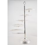Two silver-plated five tier cake stands, the circular plates pivoting on a central column,