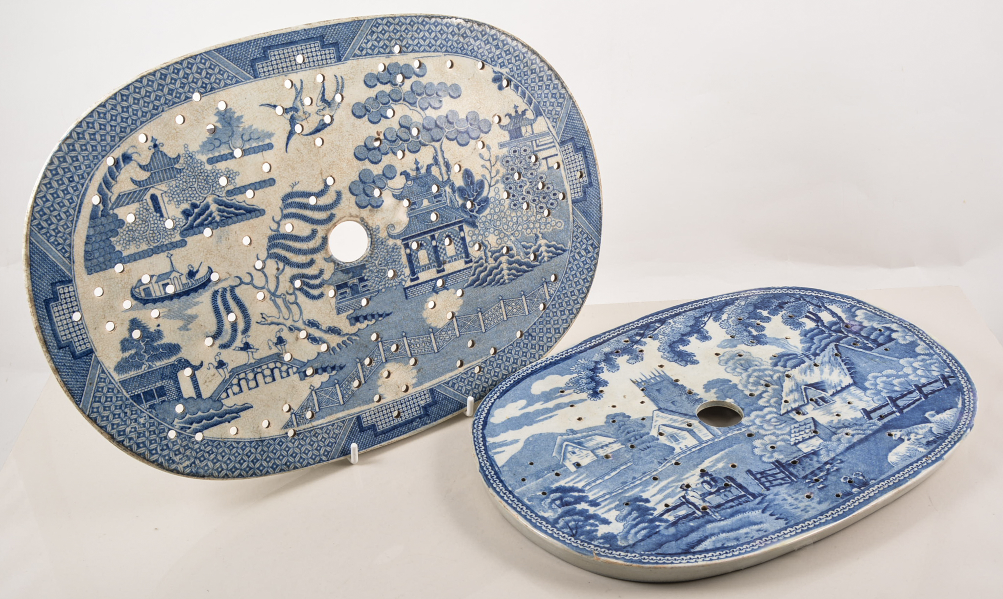 Two blue and white transfer printed ware drainers, willow pattern 33cm x 23cm,