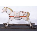 A carved and painted wood carousel horse, mounted on a wooden frame, height 90cms.