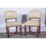 Set of eight walnut framed dining chairs, studded cream upholstery,