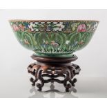 Modern Chinese Famille verte bowl 23cm diameter on wooden stand.