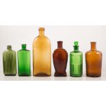 Warnes Safe Cure bottle, and other brown and green glass medicine bottles.