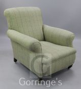 A Victorian tweed fabric upholstered armchair, on turned front legs with ceramic castors