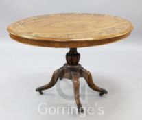 A Victorian inlaid walnut and marquetry oval looe table, on four scrolled legs, W.