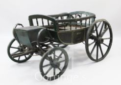 A Victorian green painted model carriage, with iron bound wheels, L.4ft 10in.