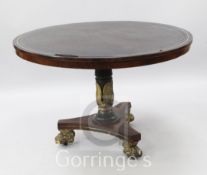 A Regency brass inset rosewood breakfast table, with gilt lions paw feet, W.3ft 9in.