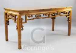 A Chinese golden wood altar type table, with scroll pierced frieze on squared legs, W.6ft 2in.