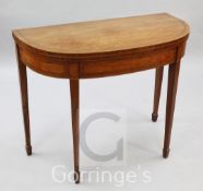 A Regency satinwood tea table, with D shaped top, on square tapered legs, W.3ft