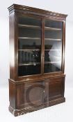 A late Victorian oak bookcase, with two glazed doors over panelled doors, W.5ft 1in.
