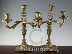 A pair of 19th century French cast brass three light candelabra, of rococo scroll form, 16in.