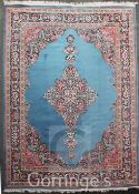 A Persian Tabriz style carpet, with central lozenge shaped floral medallion on a pale blue ground,