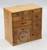 A Japanese Hakoneware walnut and marquetry miniature chest, of eight drawers, W.1ft 7in.