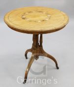 A late Victorian satinwood occasional table, the circular top inlaid with a band of scrolls and