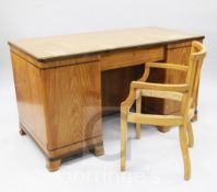 A French Art Deco golden oak and rosewood desk, the central drawer flanked by two cupboards, one