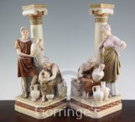 A pair of Royal Dux figure groups, late 19th century, modelled with artisans decorating amphora,