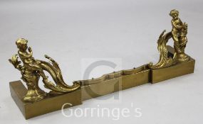 A 19th century Continental ormolu fender, with scroll and putti decoration, W.3ft 7in.