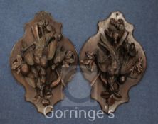 A pair of 19th century Black Forest carved and stained beech 'game' plaques, 23.5in.