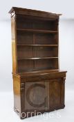 A Victorian mahogany bookcase, in two parts, with an open bookcase section above frieze drawer and a