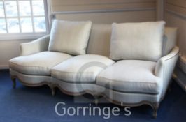 A Linley French style three seater settee, with serpentine front and woven fabric upholstery (