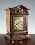 An Edwardian carved walnut architectural cased bracket clock, 16.5in. and an inlaid mahogany bracket