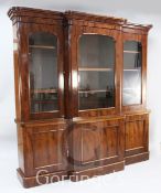 A Victorian mahogany breakfront library bookcase, with moulded cornice and three glazed doors over