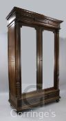 A French walnut two door armoire, late 19th century with a pair of mirrored doors above a base