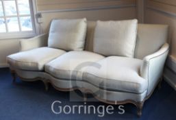 A Linley French style three seater settee, with serpentine front and woven fabric upholstery (