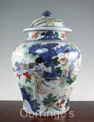 A Chinese wucai large jar and cover, in transitional style, painted with ladies and children playing