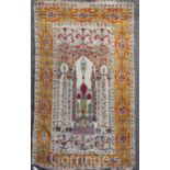 A Persian prayer rug, with central mihrab, on a beige and mustard ground, with three row border, 6ft