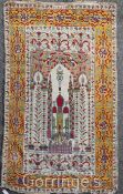 A Persian prayer rug, with central mihrab, on a beige and mustard ground, with three row border, 6ft