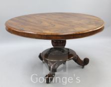 A Victorian rosewood breakfast table, with fluted stem and scroll feet, W.4ft 4in.