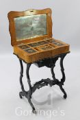 A French walnut and marquetry sewing table, inlaid fitted interior, ebonised borders and underframe,