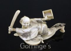 A Japanese ivory okimono of a ratcatcher, Meiji period, the figure crouching and holding a stick and
