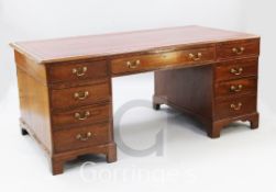 A Victorian mahogany partner's desk, with tooled red skiver, six frieze drawers and six pedestal